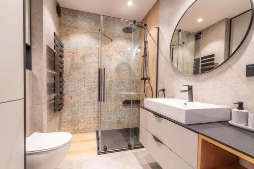 a bathroom with a sink and a shower at Lake Chill Apartment in Ostróda