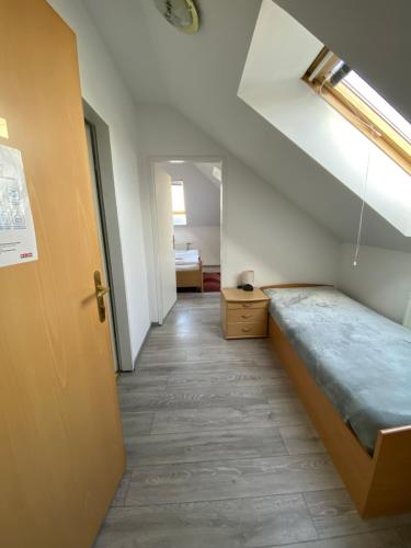 a room with a bed and a hallway with a door at Pension Lizzi in Vienna