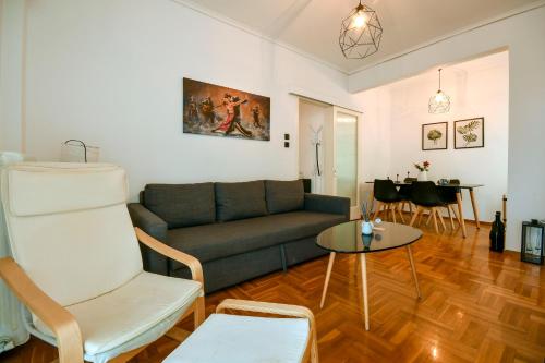 a living room with a couch and a table at Thessaloniki City Apartment Center in Thessaloniki