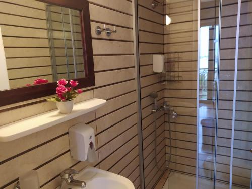 a bathroom with a toilet and a glass shower at Sea Front Old Town in Rethymno Town