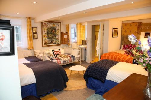 a hotel room with two beds and a couch at Annamult Country House Estate in Kilkenny