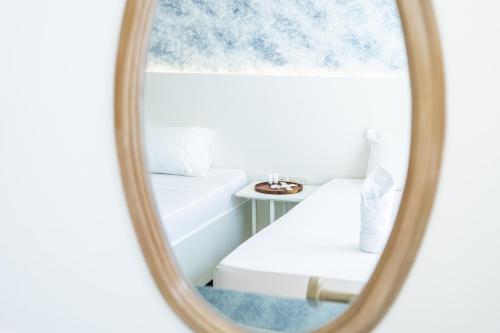 a mirror image of a bed and a table at The Garden Galleries Boutique Hotel in Pilar