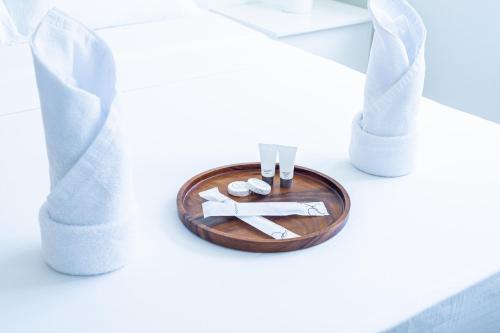 a table with a plate with napkins and utensils at The Garden Galleries Boutique Hotel in Pilar