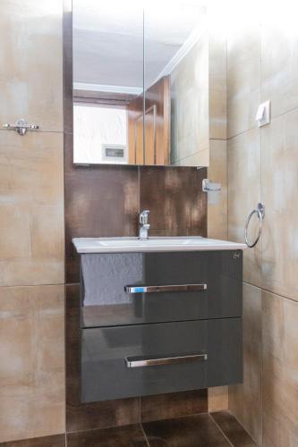 a bathroom with a sink and a mirror at Villa Repas in Pefkochori