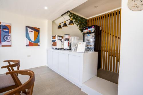 a coffee shop with a counter and a refrigerator at The Garden Galleries Boutique Hotel in Pilar