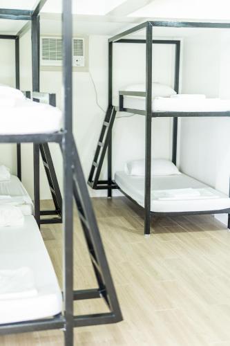a group of bunk beds in a room at The Garden Galleries Boutique Hotel in Pilar