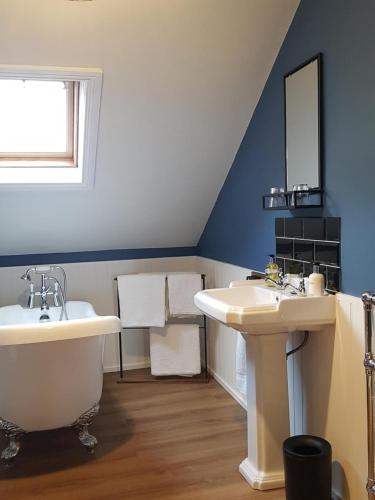 a bathroom with two sinks and a tub and a mirror at Park Dene Room only----Direct Booking for best rates in Whitby