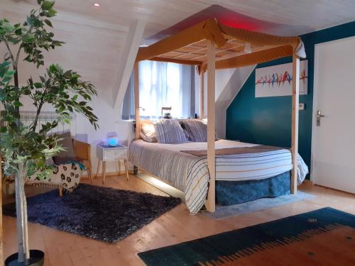 a bedroom with a bed with a canopy at Locarn Lodge, Goas Rep in Locarn