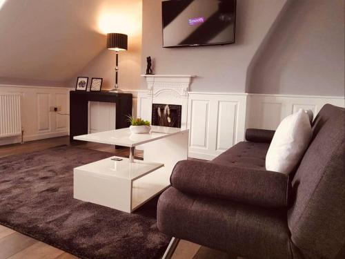 a living room with a couch and a table at Park Dene Room only in Whitby