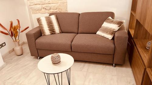 a living room with a couch and a table at LUXURY ROOM CASSESE in Ceglie Messapica