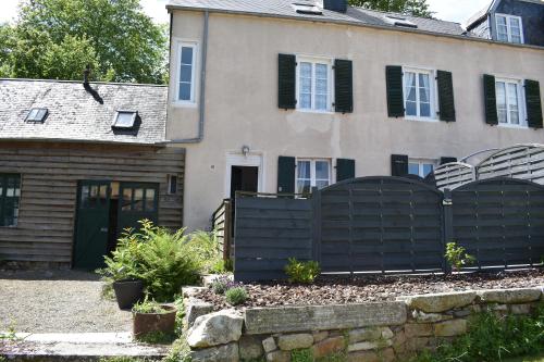 a black fence in front of a house at Gites in Le Neufbourg -Mortain in Le Neufbourg