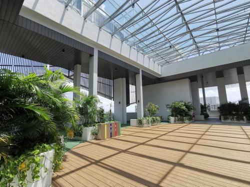 arium of a building with plants and a glass ceiling at Almas Muji Studio 100mbps Netflix STAY in Nusajaya
