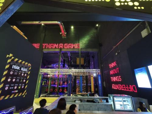 a store with a sign that says we them a game at Almas Muji Studio 100mbps Netflix STAY in Nusajaya