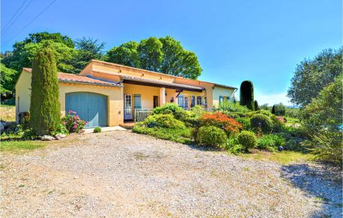 a house with a blue garage in a garden at Gorgeous Home In Montaren Et St Mediers in Labaume