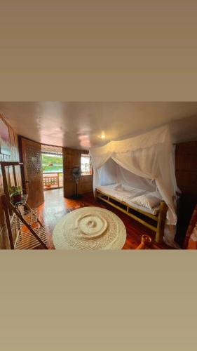 a bedroom with a bed in a tent with a rug at Camiguin Blue Lagoon Cottages in Mahinog