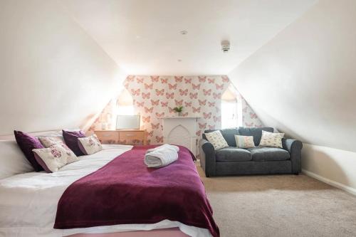 a bedroom with a large bed and a couch at St Anne's House in Plymouth