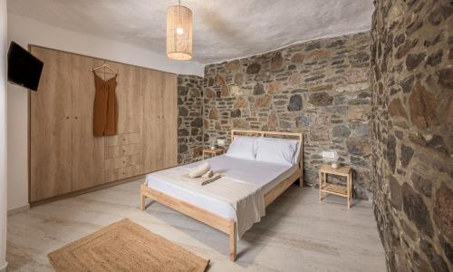 A bed or beds in a room at Salty Caves Apartments Milos