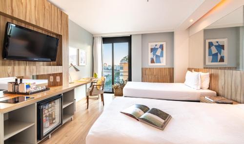 Cama ou camas em um quarto em Pestana Rio Atlantica