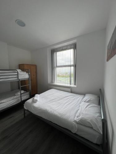 a bedroom with two bunk beds and a window at Westgate Apartments in Newcastle upon Tyne