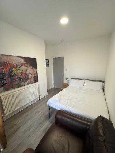a bedroom with a bed and a couch in it at Westgate Apartments in Newcastle upon Tyne