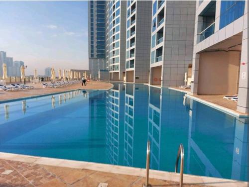 an empty swimming pool in a building with buildings at full sea view 2 bhk apartment in Ajman 