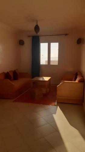 a living room with a couch and a table at Résidence Louzani in Essaouira