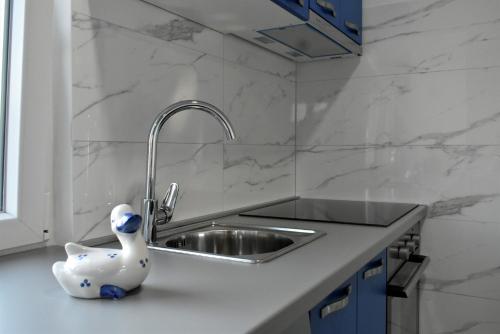 a kitchen with a sink and a toy duck on the counter at Apartmani Škorpion in Kaštela