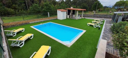 a large swimming pool with chairs and avisor at House in Vila Nova de Cerveira with Pool and BBQ #1881 in Campos