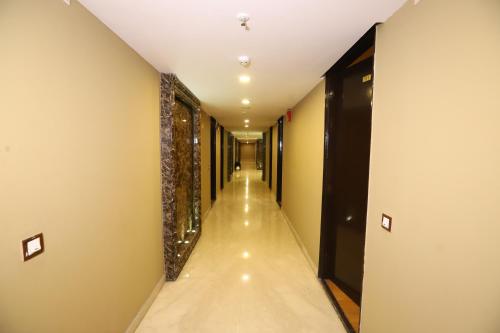 a corridor of a hotel with a long hallway at Hotel Palm Grand Naraina New Delhi - Couple Friendly Local IDs Accepted in New Delhi