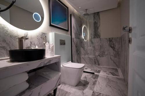 a bathroom with a sink and a toilet at Prime Al Corniche Hotel in Jeddah