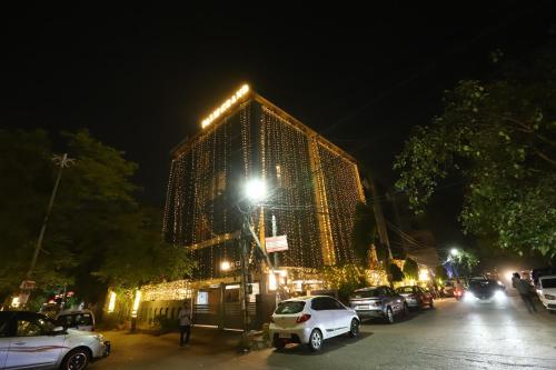 a large building is lit up at night at Hotel Palm Grand Naraina New Delhi - Couple Friendly Local IDs Accepted in New Delhi