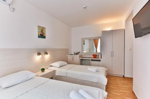 a hotel room with two beds and a kitchen at Villa Skyprime in Budva