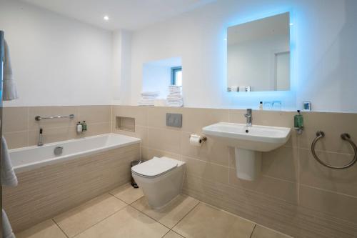 a bathroom with a toilet and a sink and a bath tub at Portavadie Loch Fyne Scotland in Portavadie