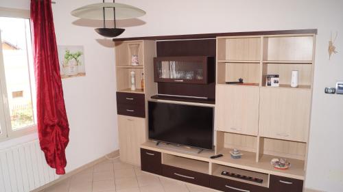 a entertainment center with a large television in a living room at Bed and Breakfast da Nonna Ezia in Albenga