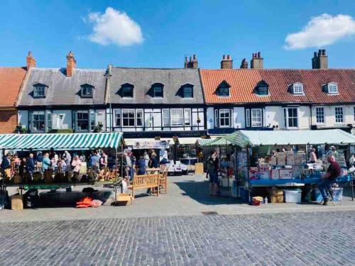 a large building with a market in front of it at Beverley Snug in Beverley