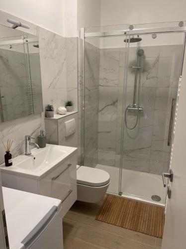 a bathroom with a shower and a toilet and a sink at Apartment Meri in Korčula