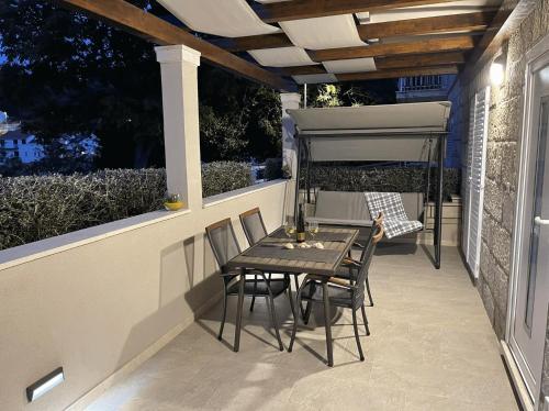 a patio with a table and chairs on a porch at Apartment Meri in Korčula