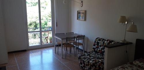 a living room with a table and a chair at Sportrek in Levanto