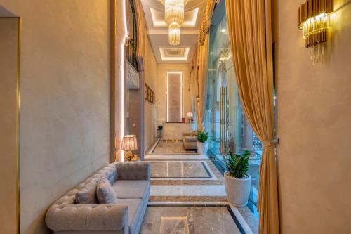 a hallway with a living room with a couch at Golden Tree Hotel & Apartment in Ho Chi Minh City