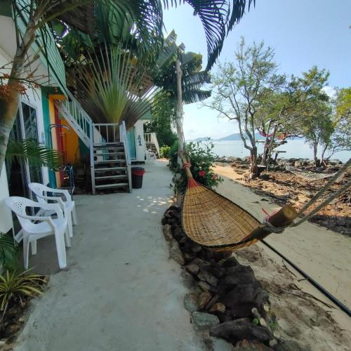 a hammock hanging from a house on the beach at Rasta view Bangalows in Ko Chang