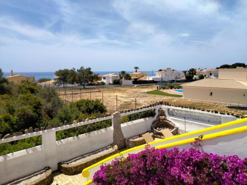 a view from the balcony of a house with flowers at Vila Horizonte in Carvoeiro