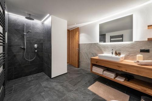 a bathroom with a sink and a shower at Mesnerhof in Valles