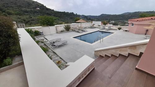 a house with a swimming pool in a yard at Georgioupoli Studios in Georgioupolis
