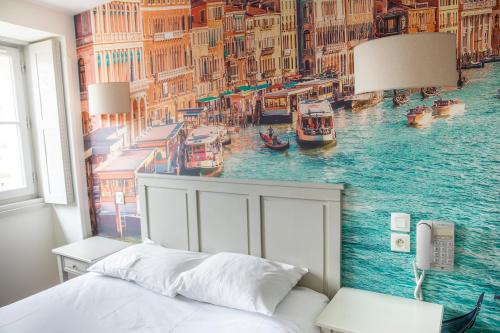 a bedroom with a mural of a canal at Hotel Bleu de Mer in Bordeaux