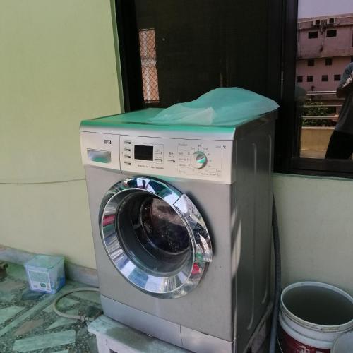 a washing machine with a green top on top of it at newahome in Pātan