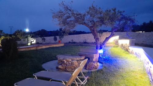 a table and chairs under a tree in a yard at Georgioupoli Studios in Georgioupolis