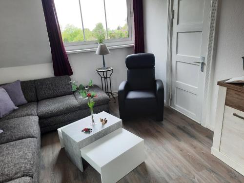 a living room with a couch and a chair at Stefanie in Heide