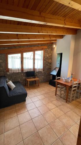a living room with a couch and a table at Apartaments Cal Borda in Coll de Nargó