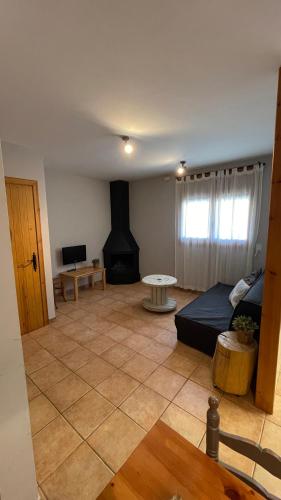 a living room with a couch and a fireplace at Apartaments Cal Borda in Coll de Nargó