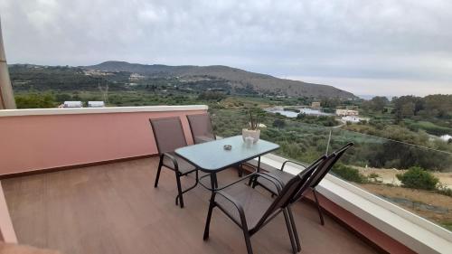a table and chairs on a balcony with a view at Georgioupoli Studios in Georgioupolis